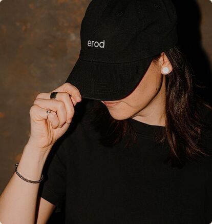 An art director wears a cap bearing the Erod marketing agency logo.