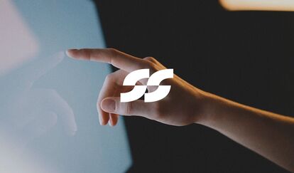 Hand touching a screen, representing the design and innovation strategy of a creative agency